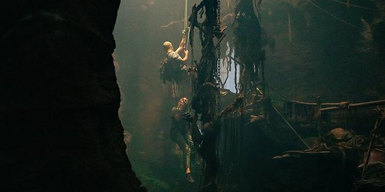 Taron Egerton and Charlize Theron going up the rope in Apex