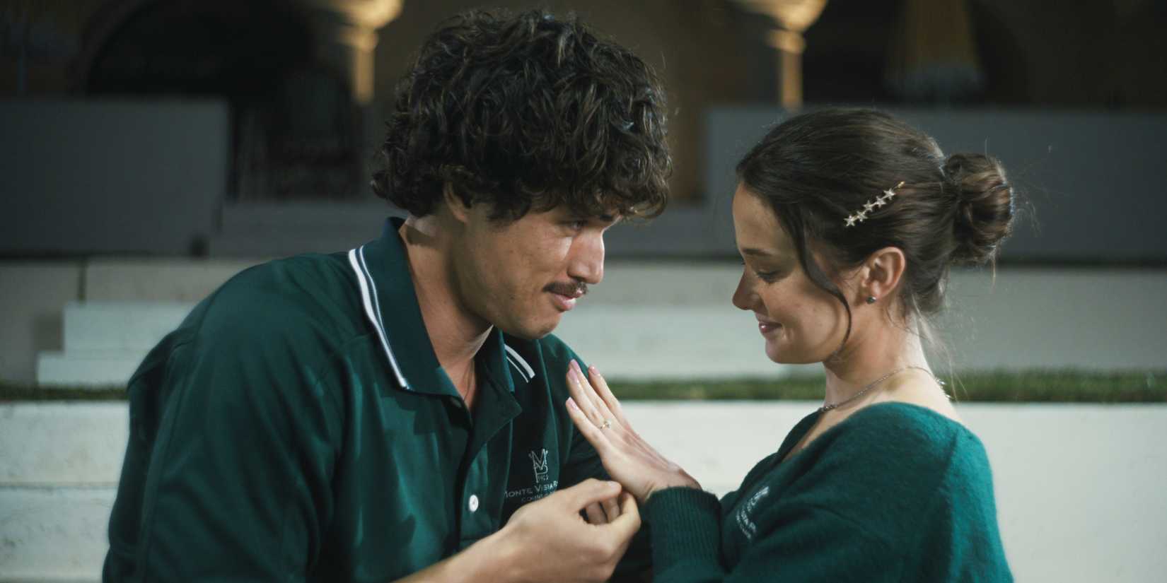 Austin embraces Ashley as she smiles at her engagement ring.