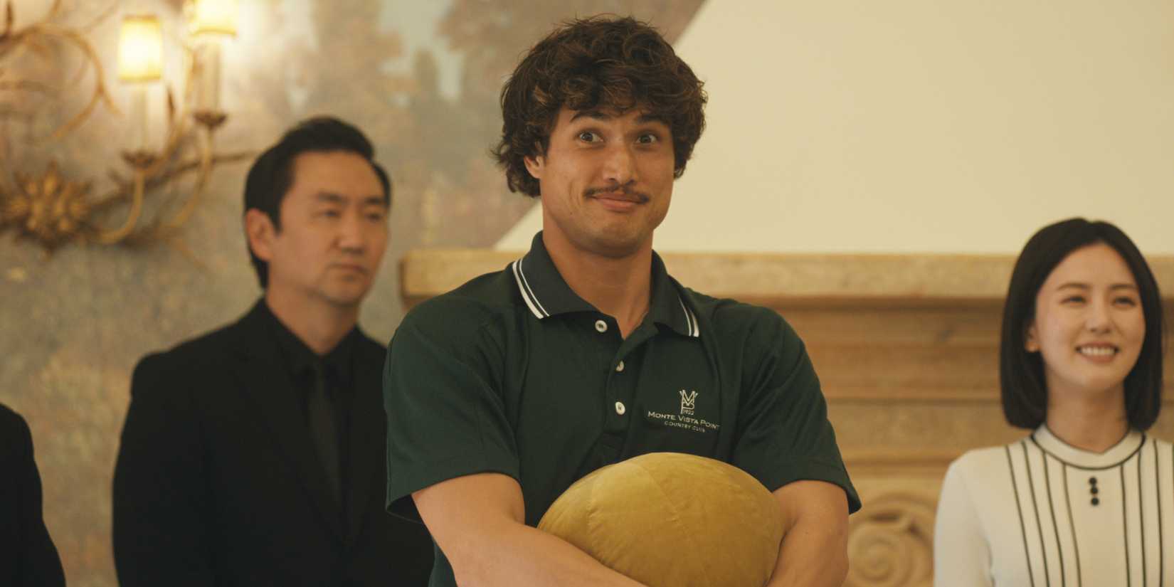 Austin Davis is standing in his country club uniform, smiling.