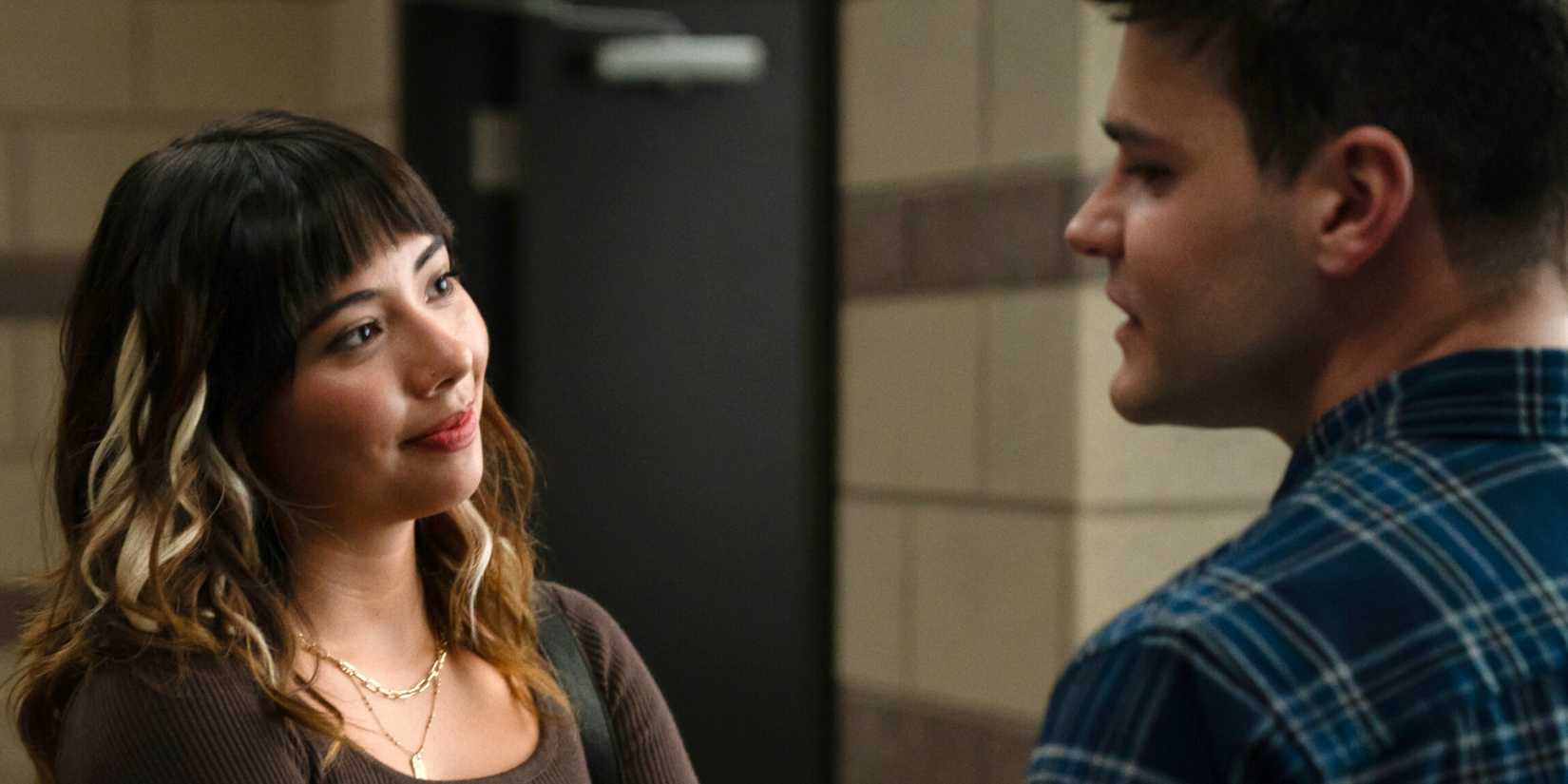 Mika Amonsen as Sean standing across from and talking to Xochitl Gomez as Penny in Boston Blue Season 1