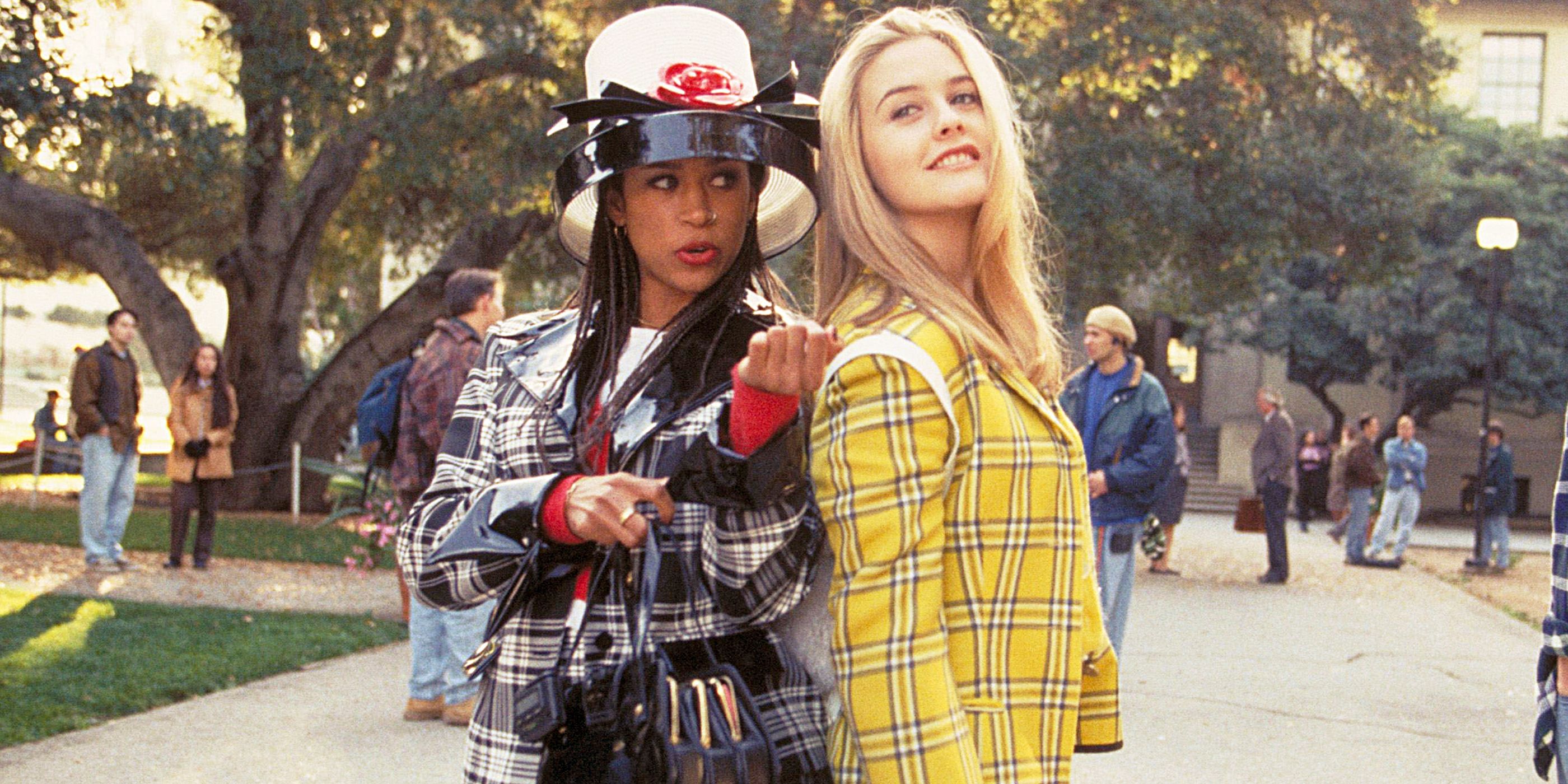 Stacey Dash and Alicia Silverstone stand back to back in plaid outfits in 'Clueless' image