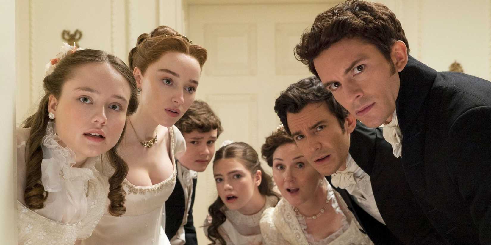 The cast of Bridgerton lean in to listen at a fancy event
