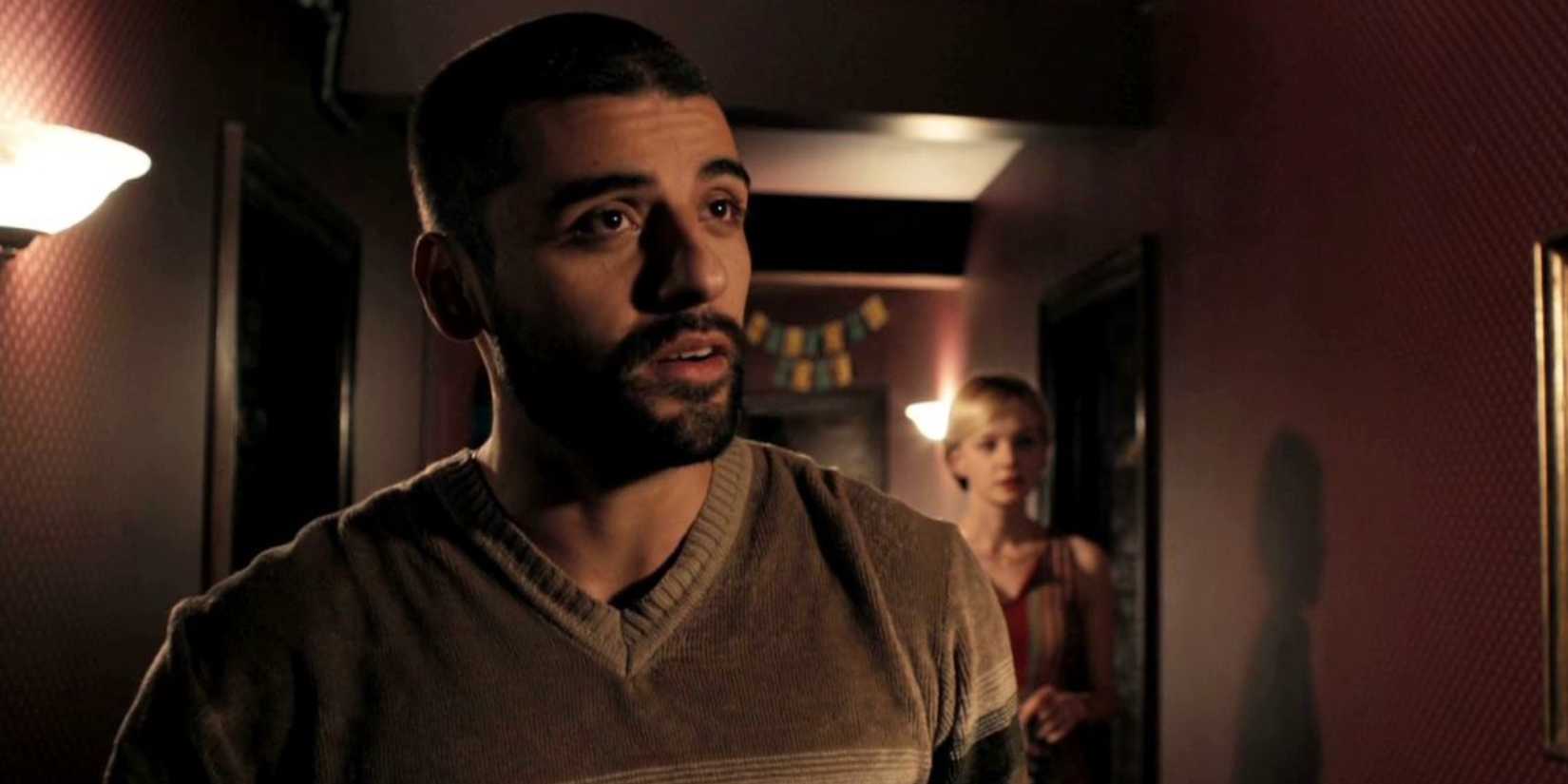 Oscar Isaac as Standard, with Carey Mulligan as Irene in the background, in "Drive"
