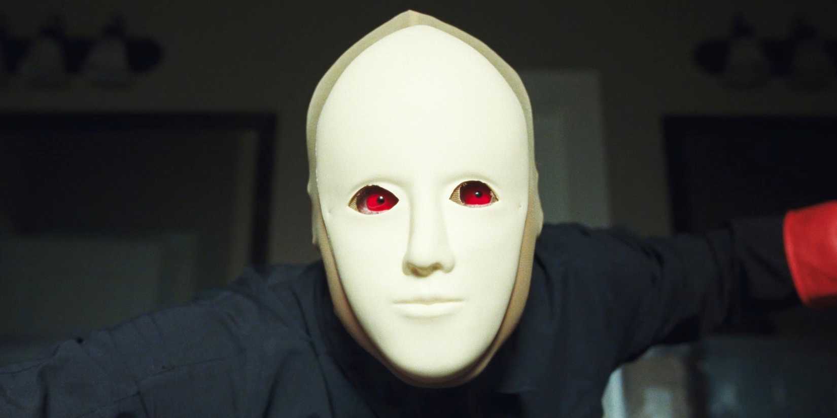 A masked man with red eyes in 2026's Faces of Death