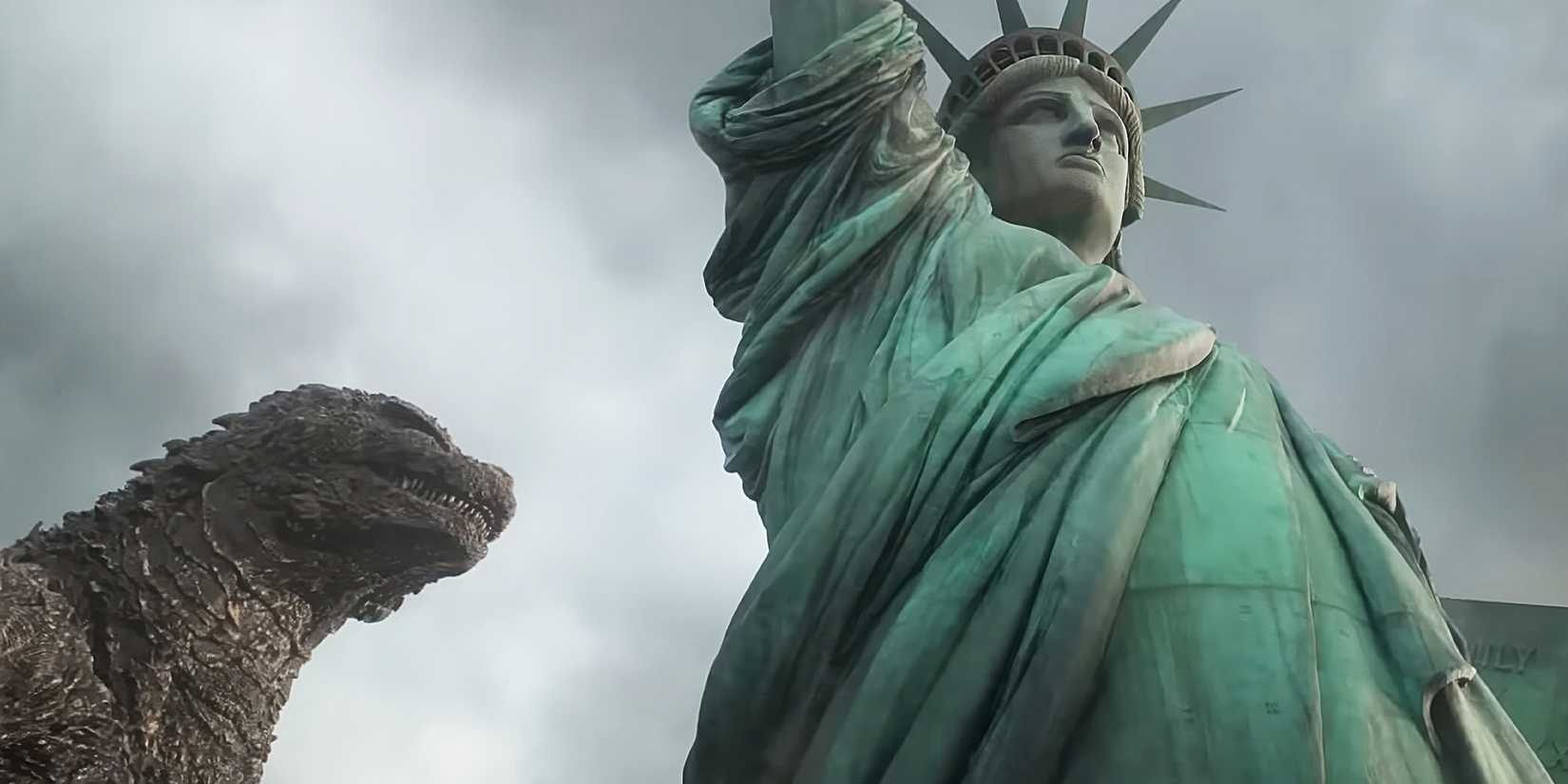 Godzilla walks by the Statue of Liberty.