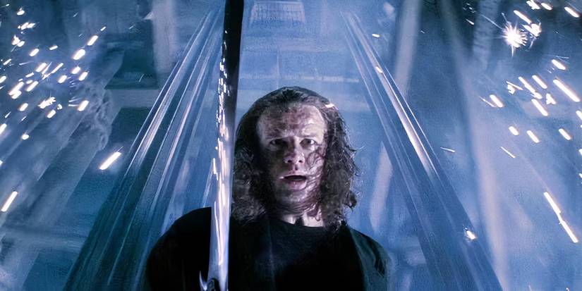 Connor MacLeod (Christopher Lambert) looks down as he holds a sword in 'Highlander II: The Quickening' (1991).