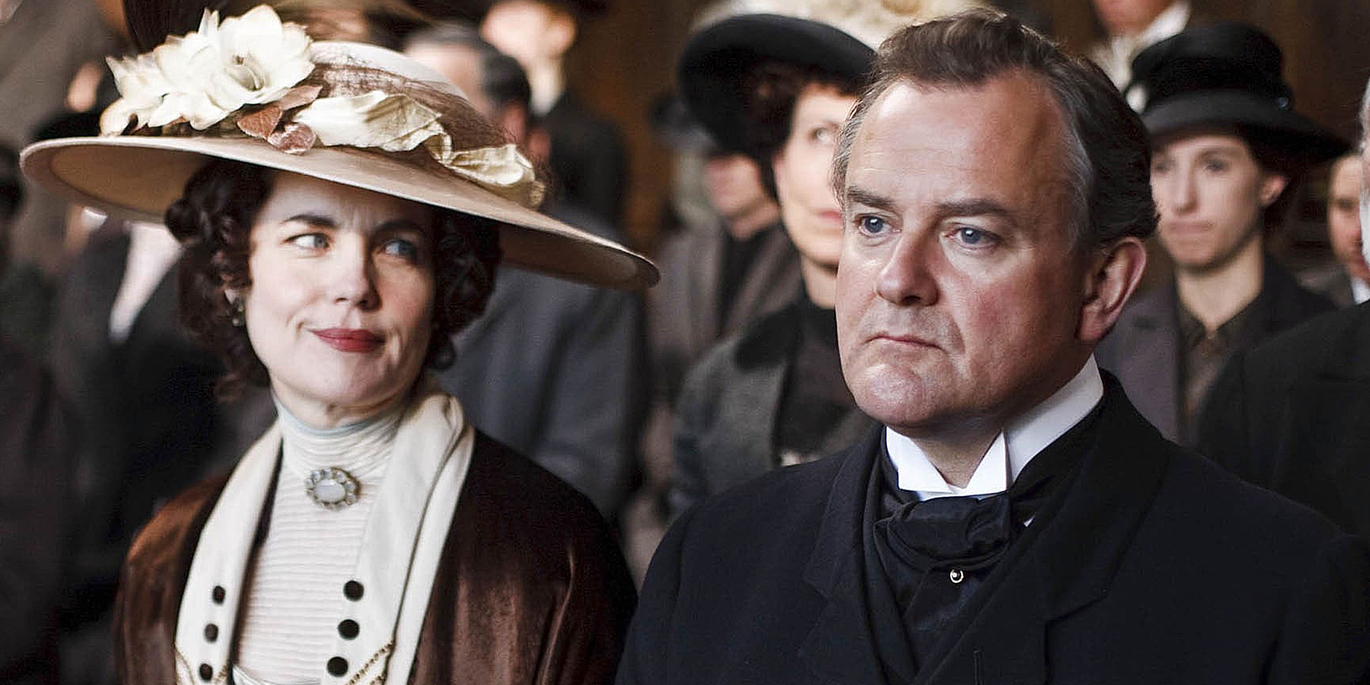 Elizabeth McGovern and Hugh Bonneville stood in a crowd in 'Downton Abbey'