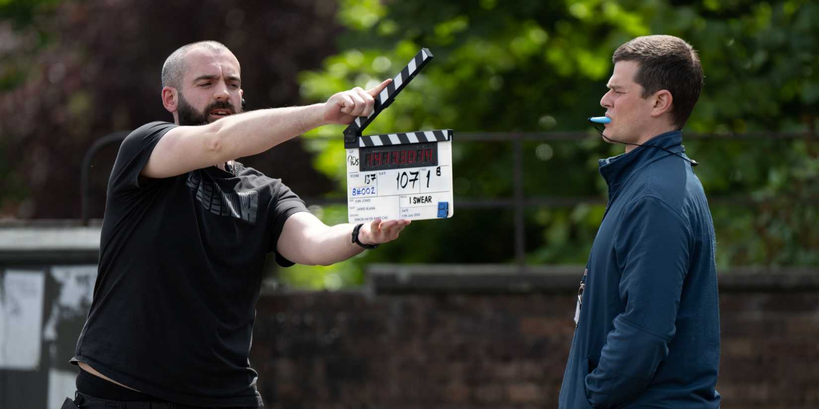 Robert Aramayo as John Davidson shooting a scene standing next tothe scene marker in I Swear