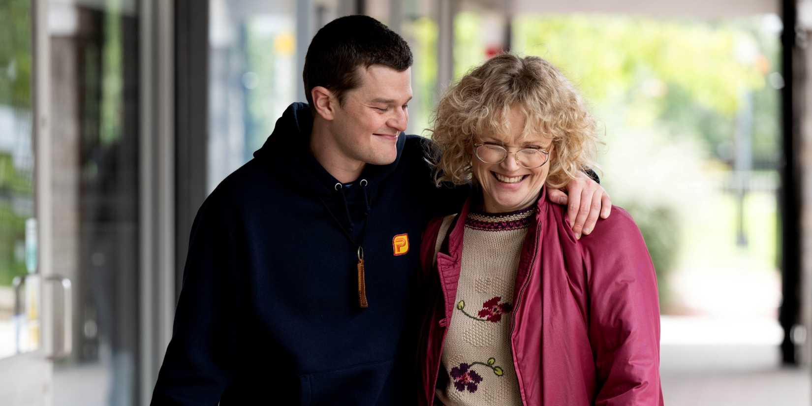 Robert Aramayo as John Davidson walking with his left arm around Maxine Peake as Dottie in I Swear