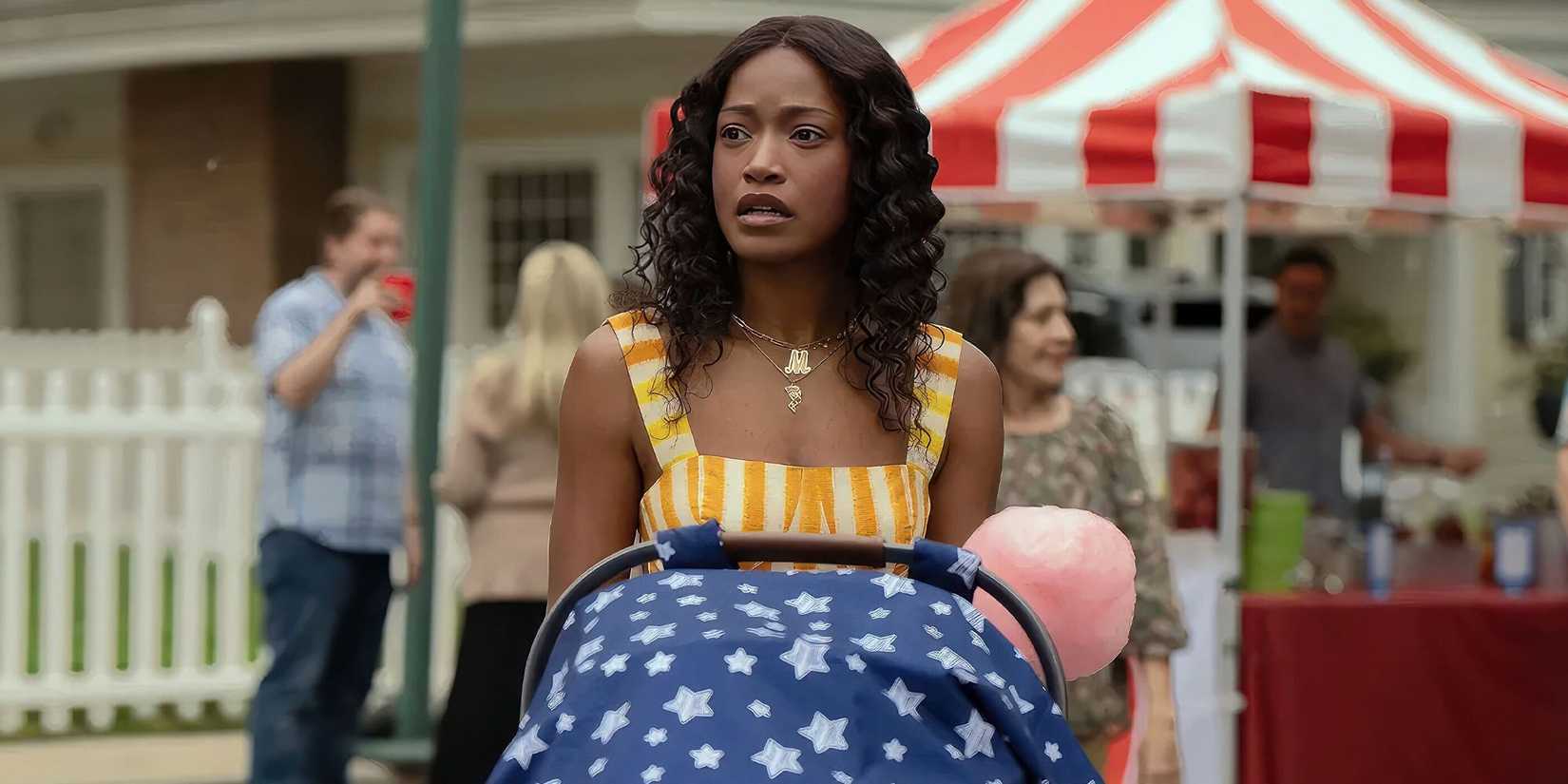 Keke Palmer as Samira pushing her baby in a stroller at a block party and looking perplexed in The ‘Burbs
