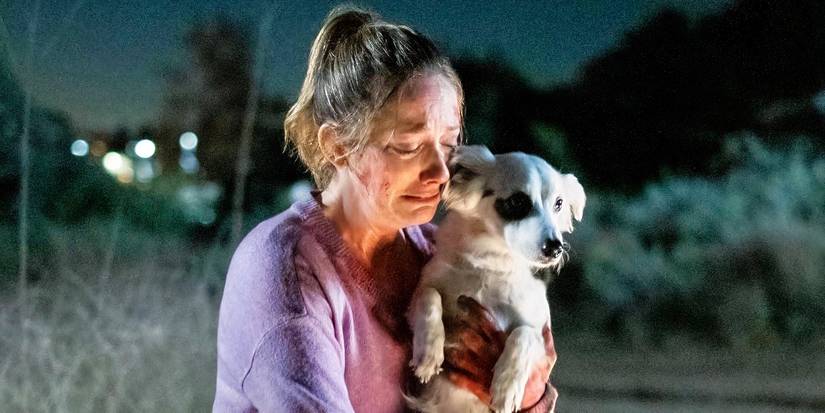 Judy Greer holding a dog in a still from Into the Dark: Good Boy.