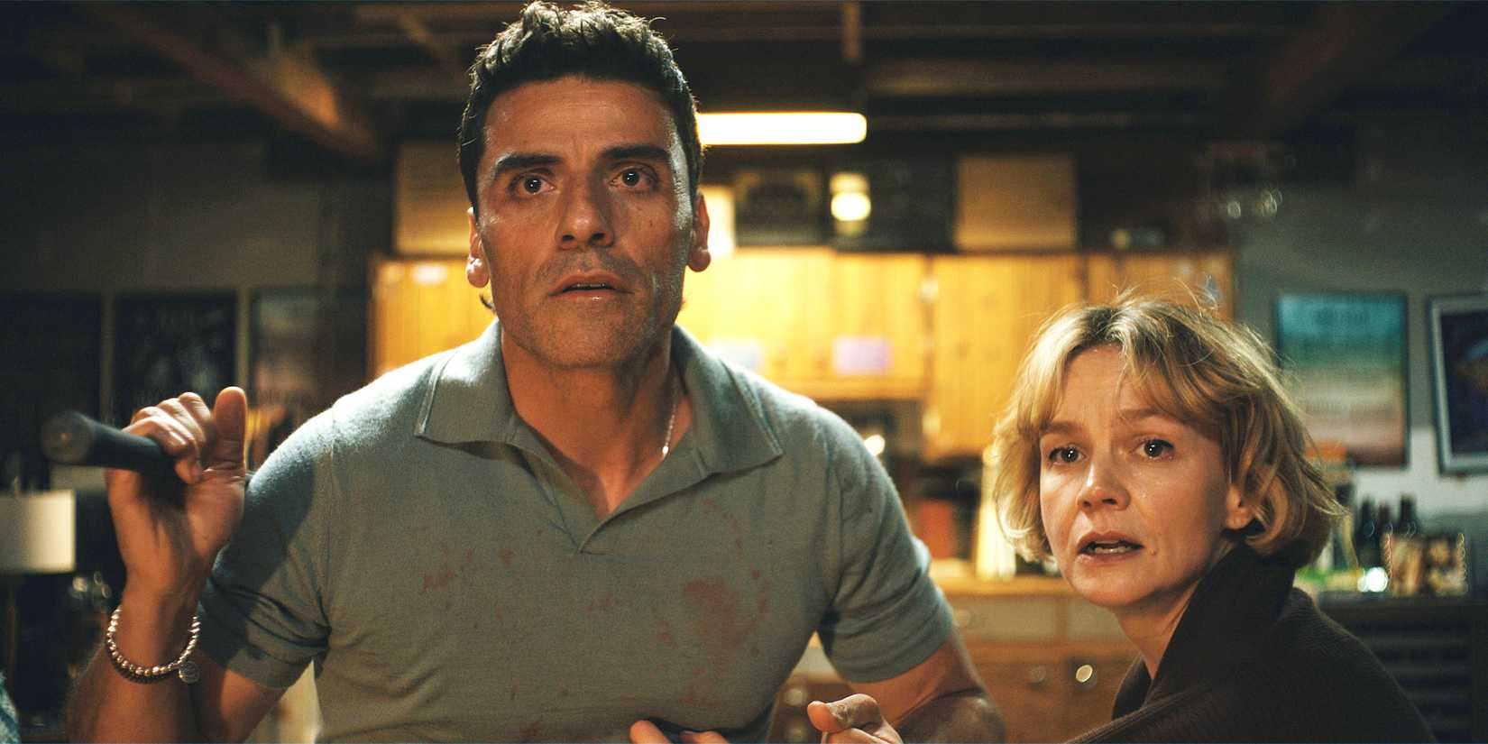 Joshua (Oscar Isaac) and Lindsay (Carey Mulligan) look toward camera, stunned.