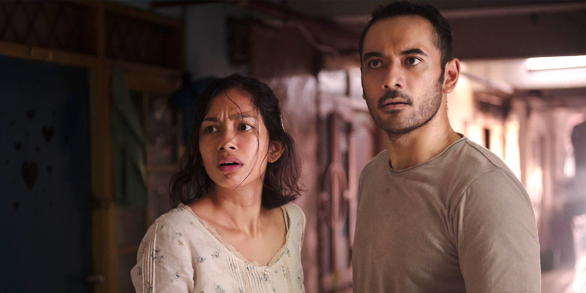A man and a woman looking worried in Joko Anwar's Nightmares and Daydreams