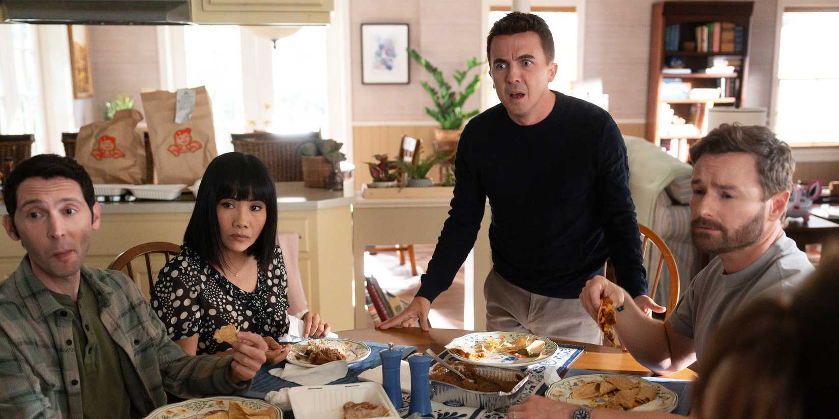 Malcolm stands up at the dinner table with a horrified expression, as Reese, Piama, and Francis look unfazed.