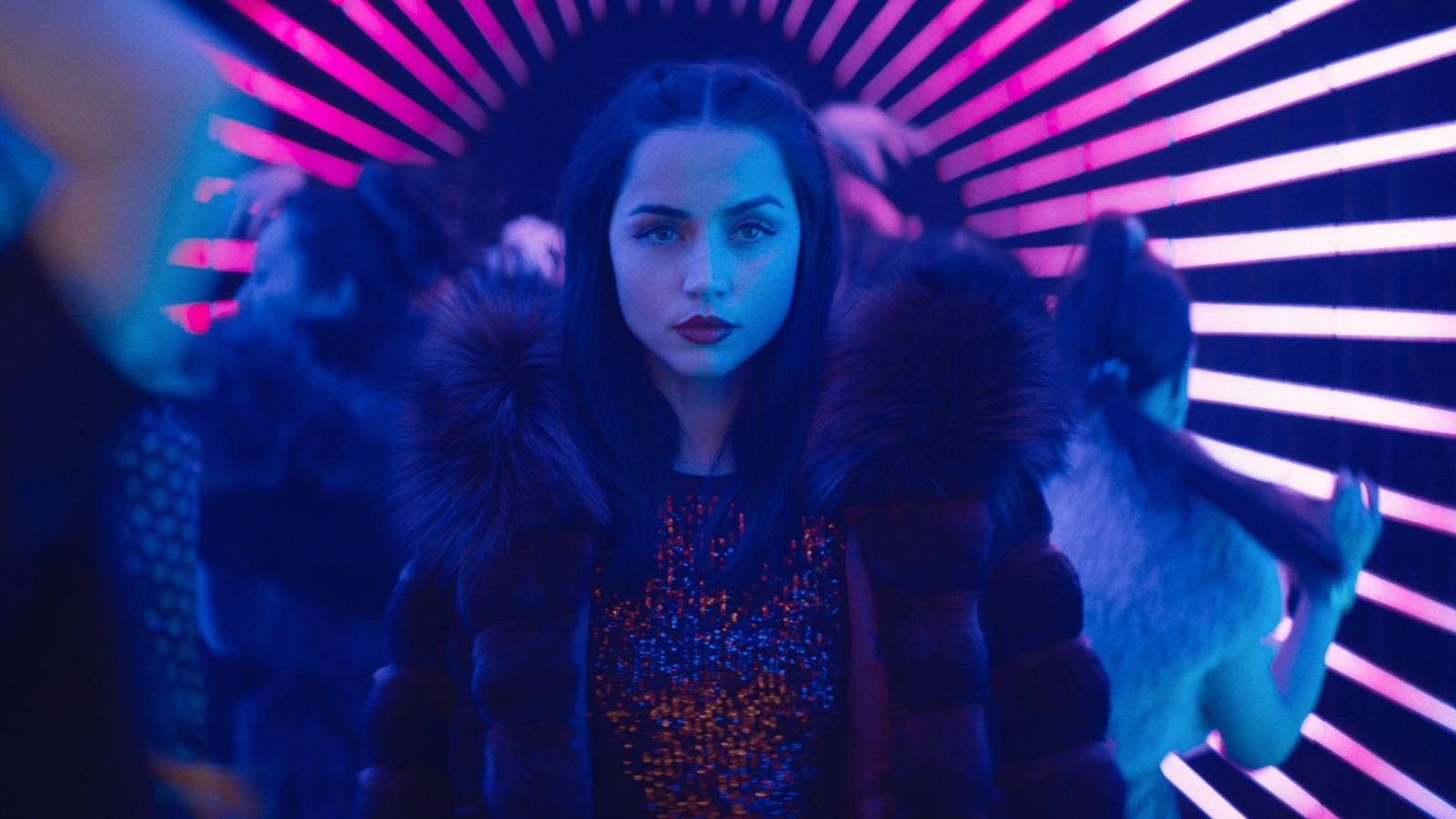 Ana de Armas stands in a neon club in Ballerina from John Wick