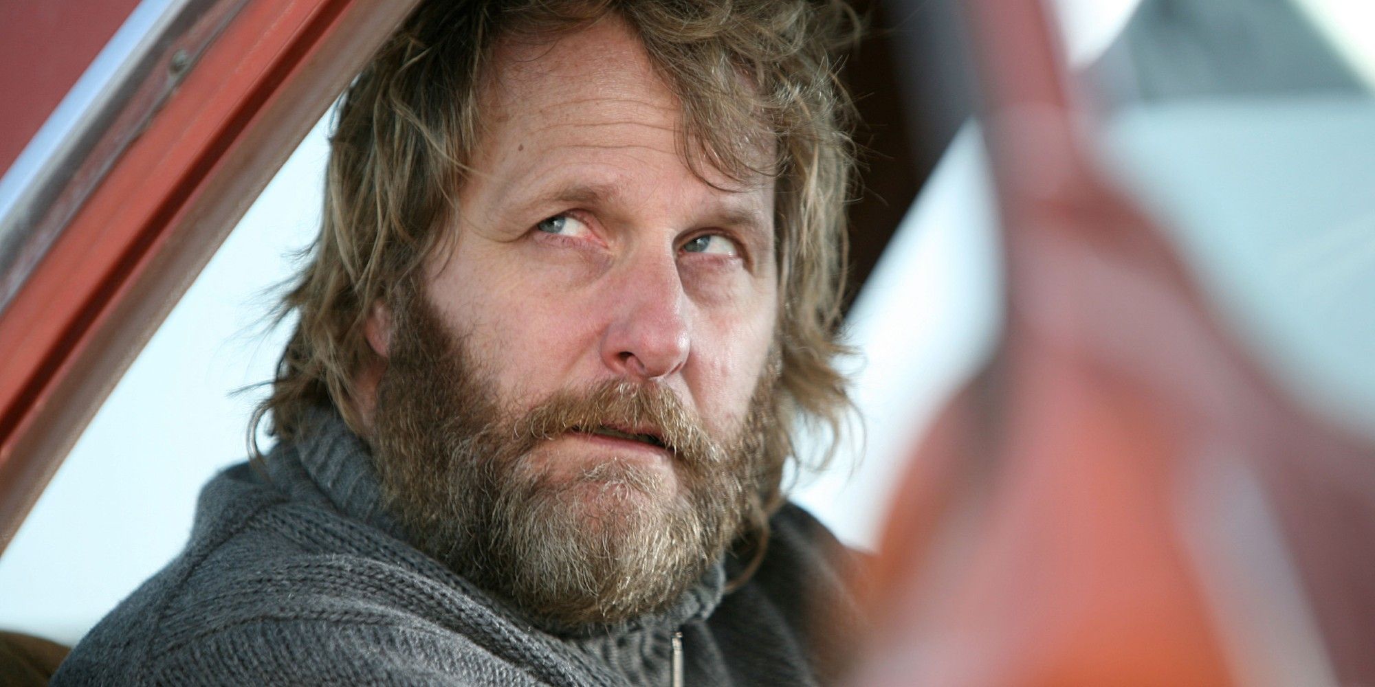 Jeff Daniels looks up from the passenger seat of a car in The Lookout
