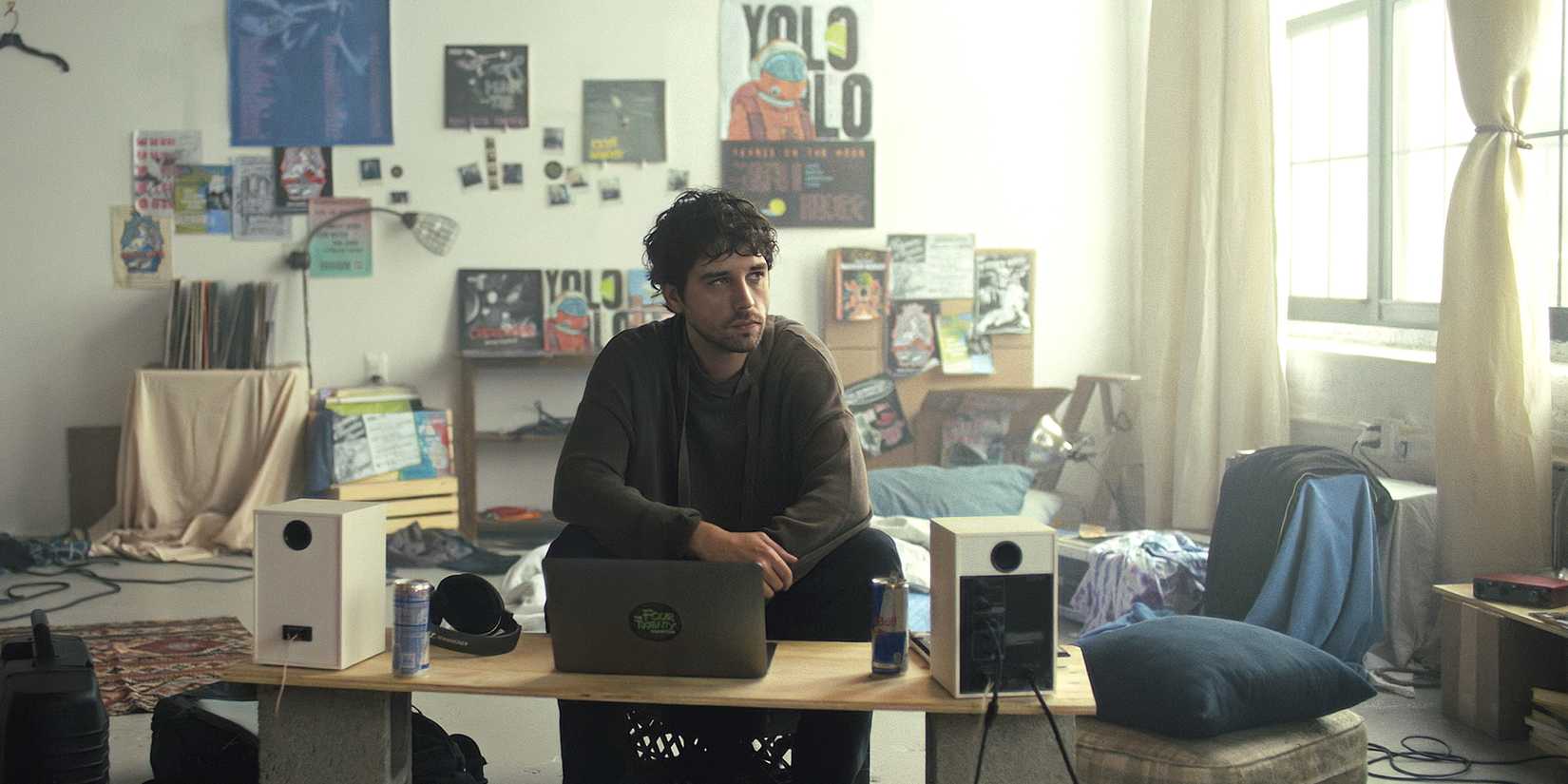 Danny sits alone in his room at a laptop.