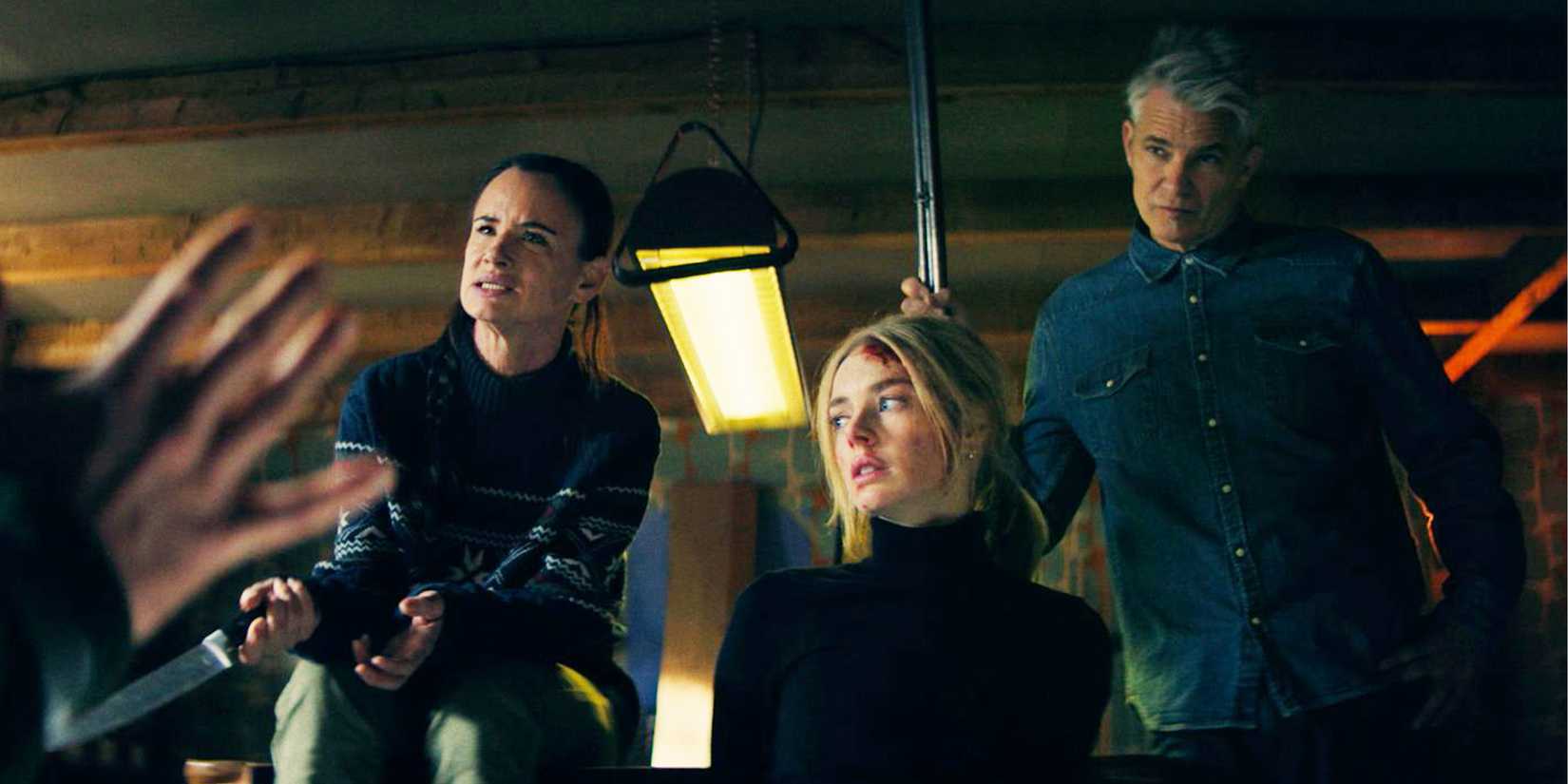 Allegra and Pete stand over Lisa with weapons, who's tied up in a chair.