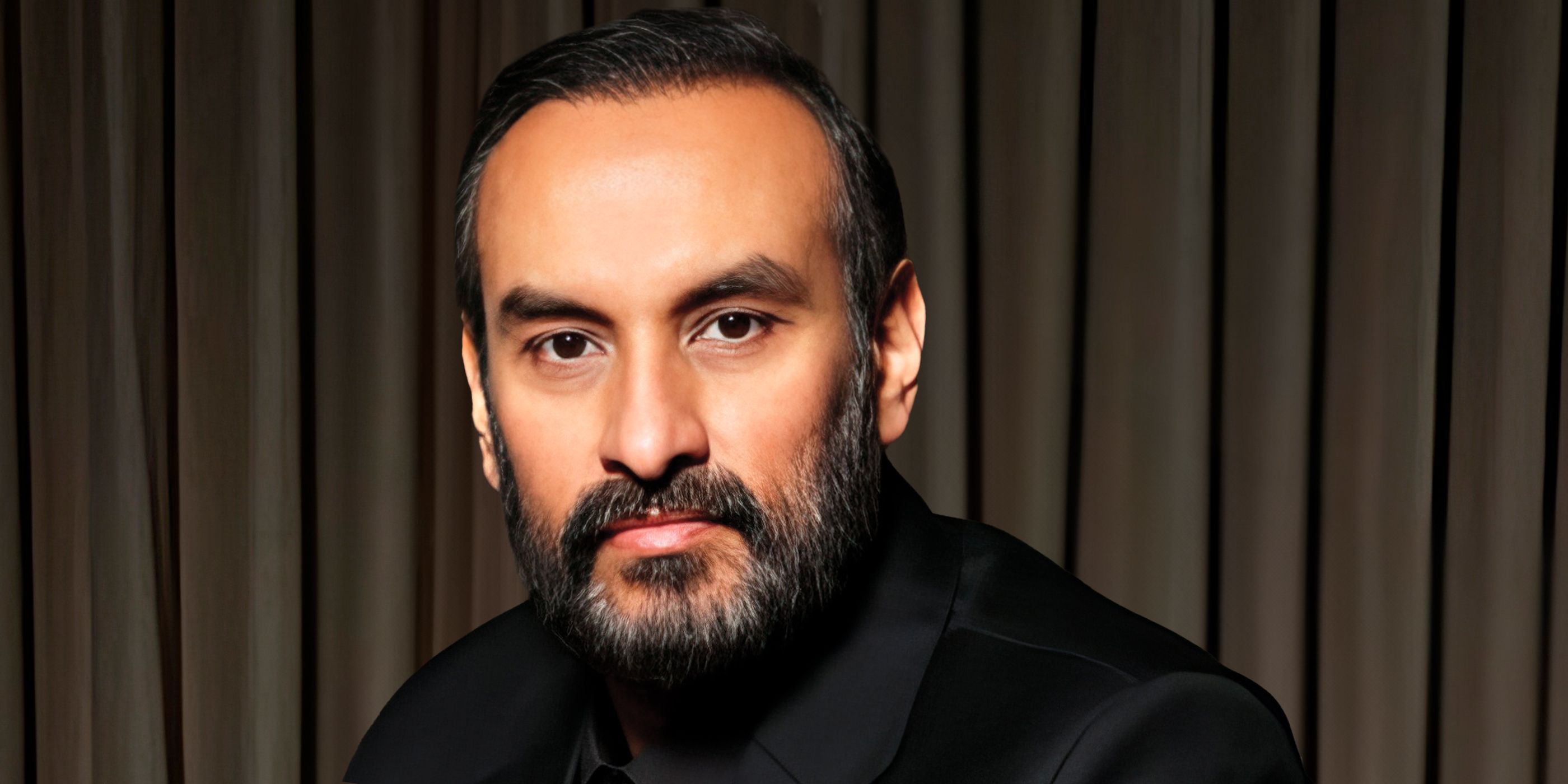 Producer Namit Malhotra in a black suit.