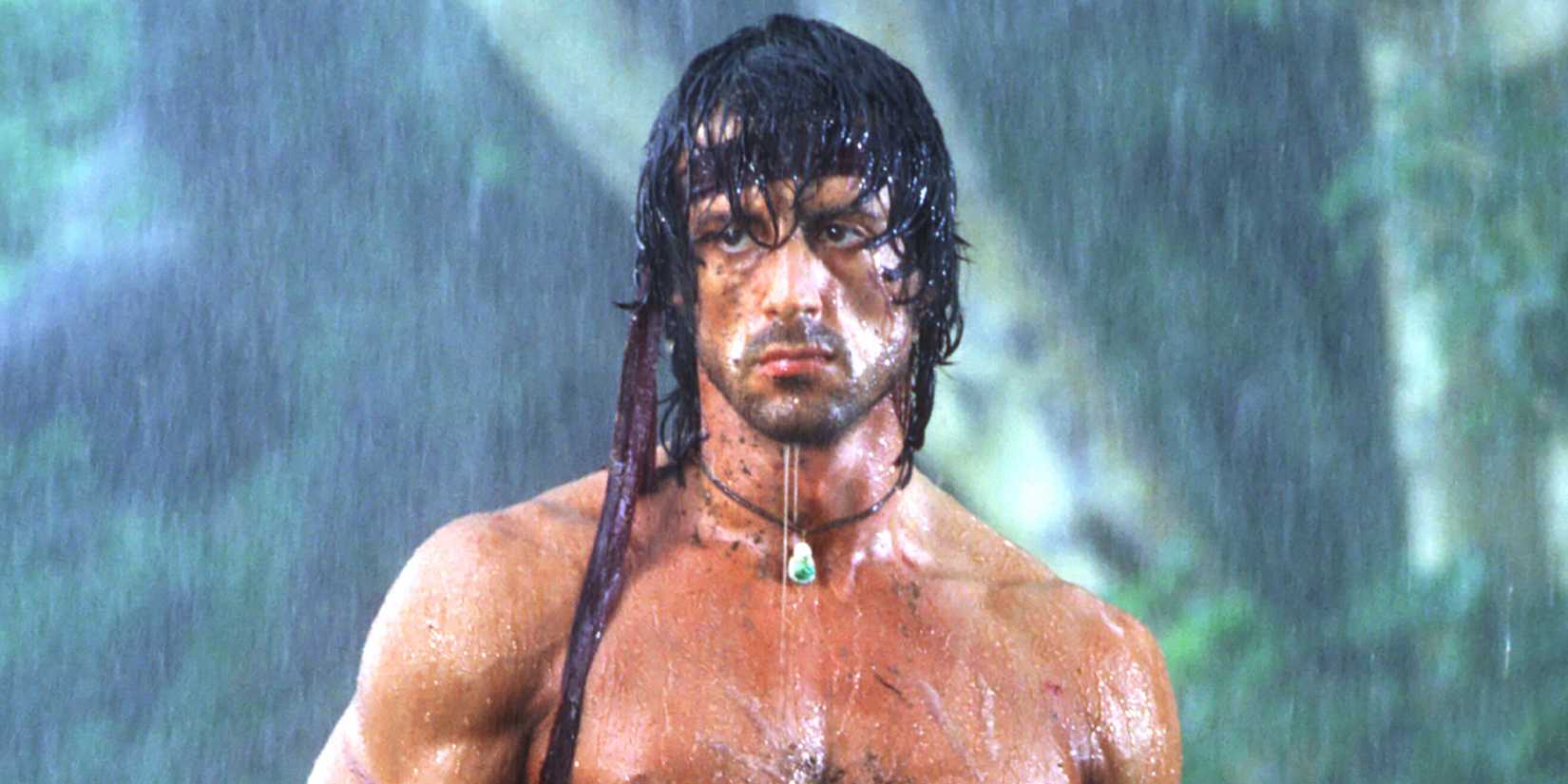 Sylvester Stallone as John Rambo, standing in the rain, in Rambo: First Blood Part II (1985)