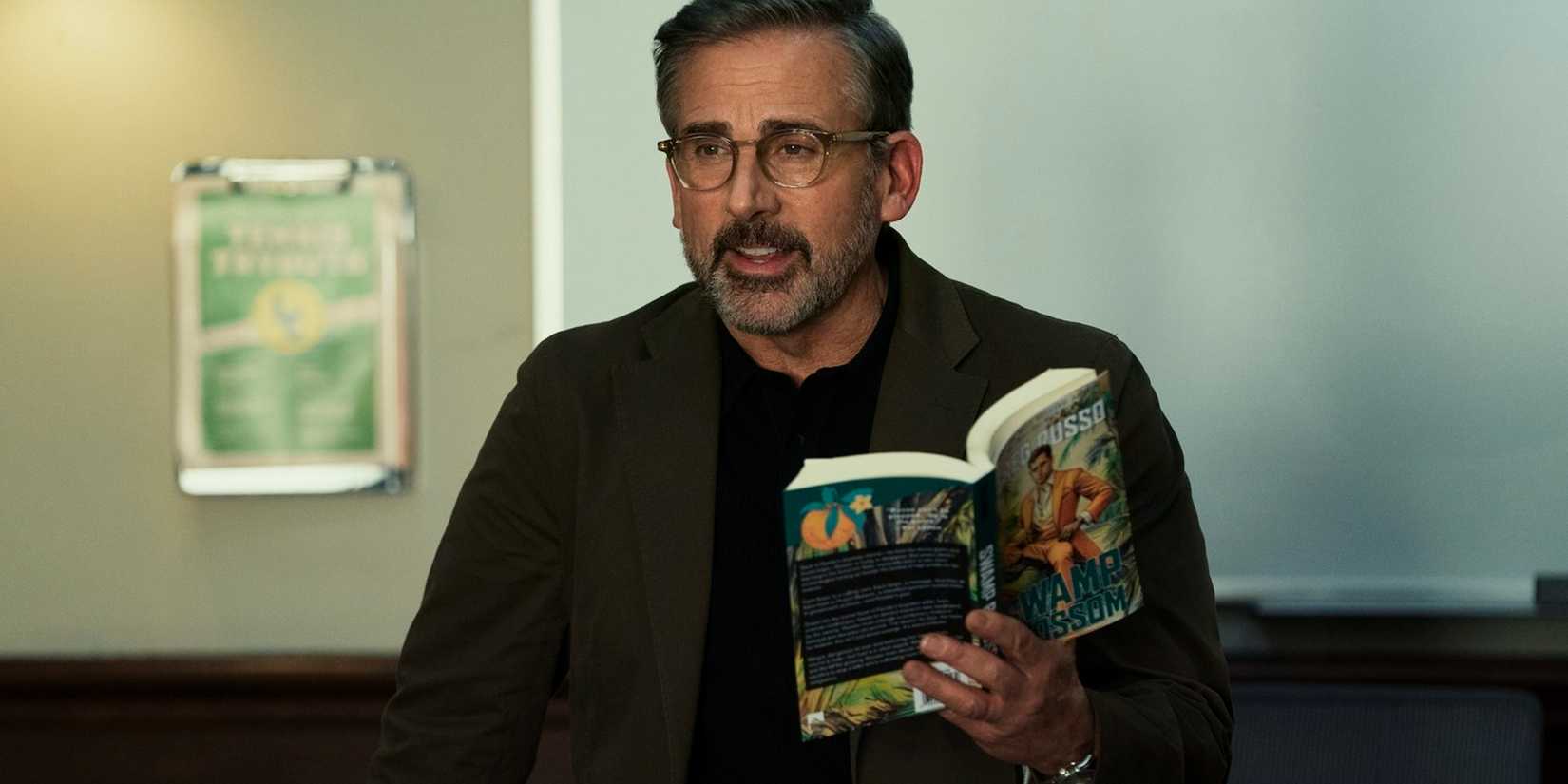 Steve Carell holding up an open book in Rooster