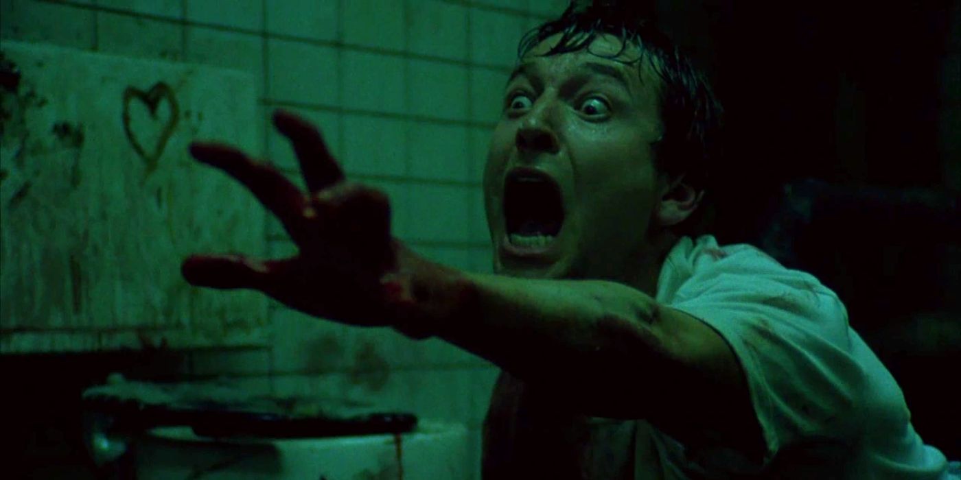 A guy reaching out in terror in the 2004 movie Saw.