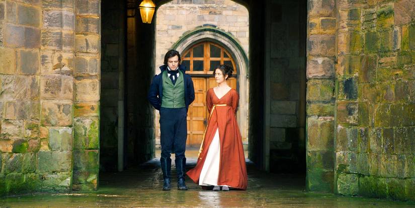 Adam e Persephone lado a lado nos terrenos do castelo em Seeking Persephone