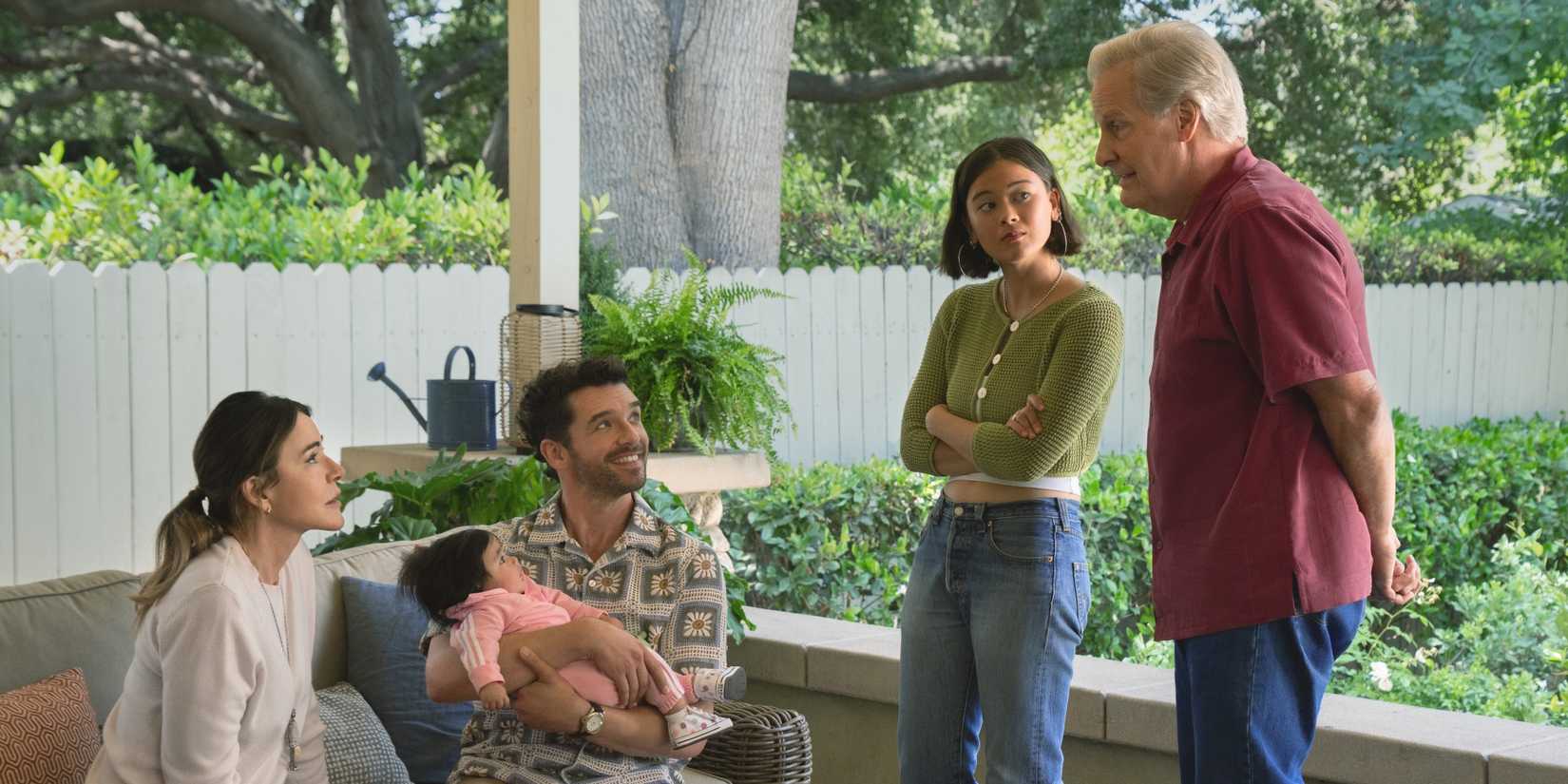 Christa Miller sitting with Michael Urie as Lukita Maxwell and Jeff Daniels stand nearby in Shrinking