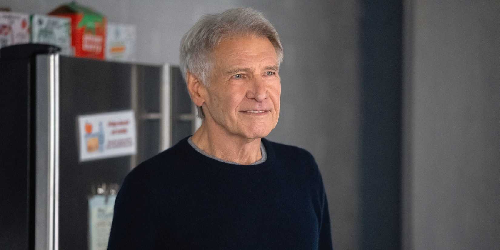 Harrison Ford as Paul standing in the office kitchen with a slight smile in Shrinking Season 3