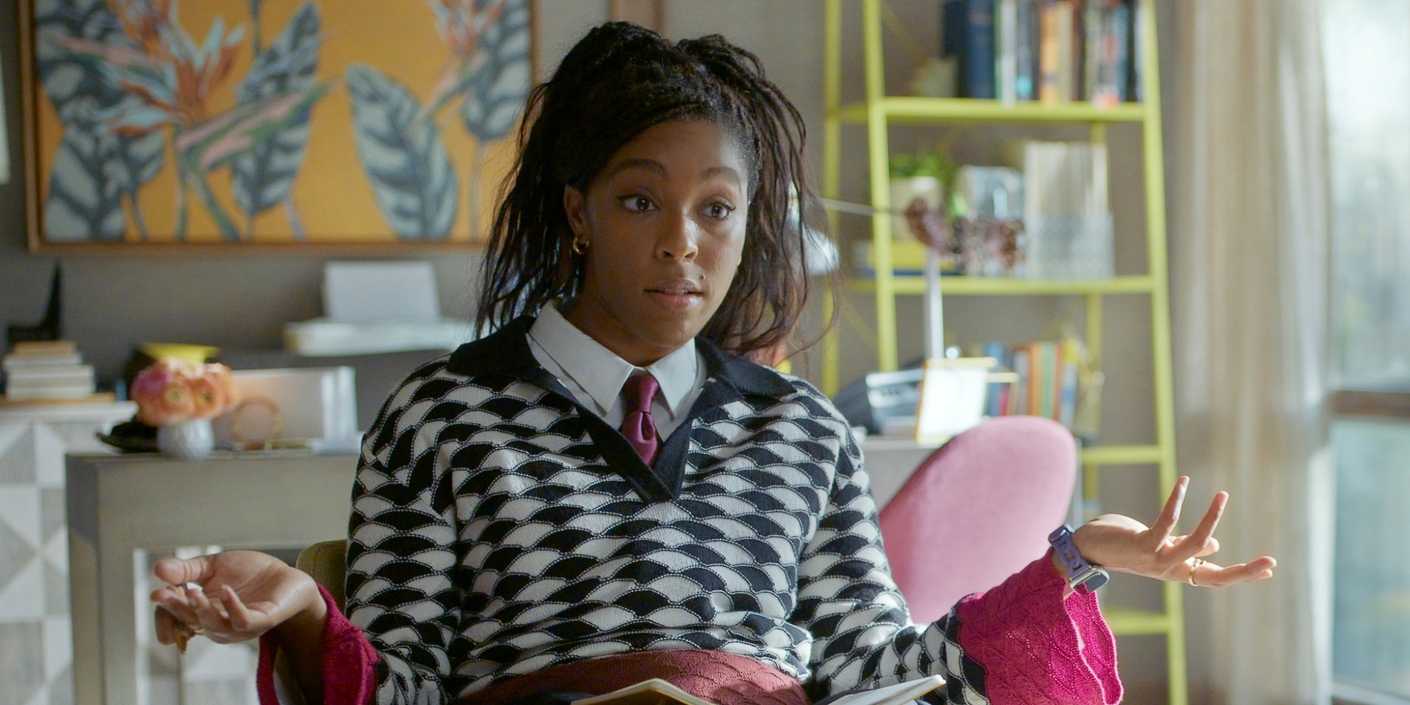 Jessica Williams as Gaby sitting in a chair and holding up both her hands in Shrinking Season 3