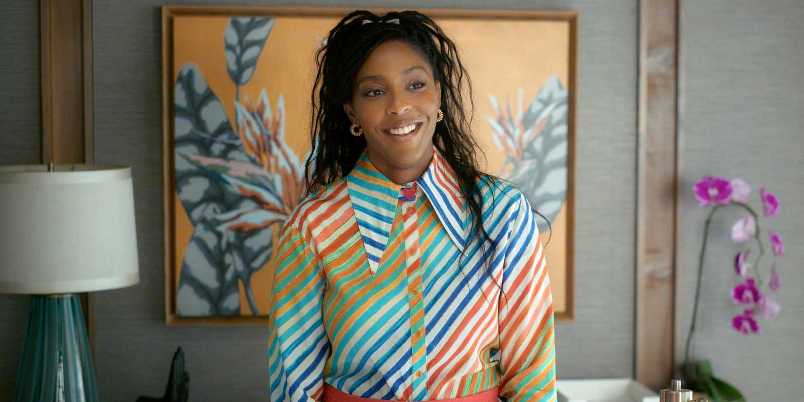 Jessica Williams as Gaby smiling in a rainbow striped button down shirt in Shrinking Season 3