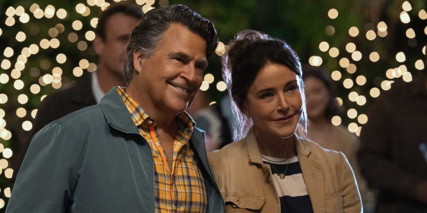 Ted McGinley as Derek standing outside and smiling with Christa Miller as Liz in Shrinking Season 3