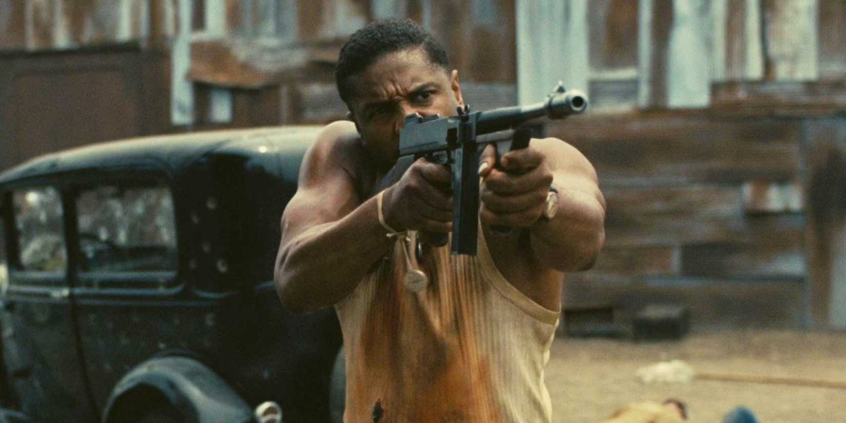 Sinners, Michael B. Jordan firing a machine gun with intensity 