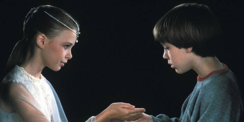 Tami Stronach puts something into Barret Oliver's hand in The NeverEnding Story