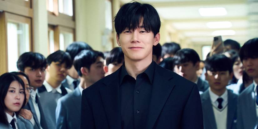 Kim Mu-yeol smiling in front of a large group of students in a school in Teach You a Lesson