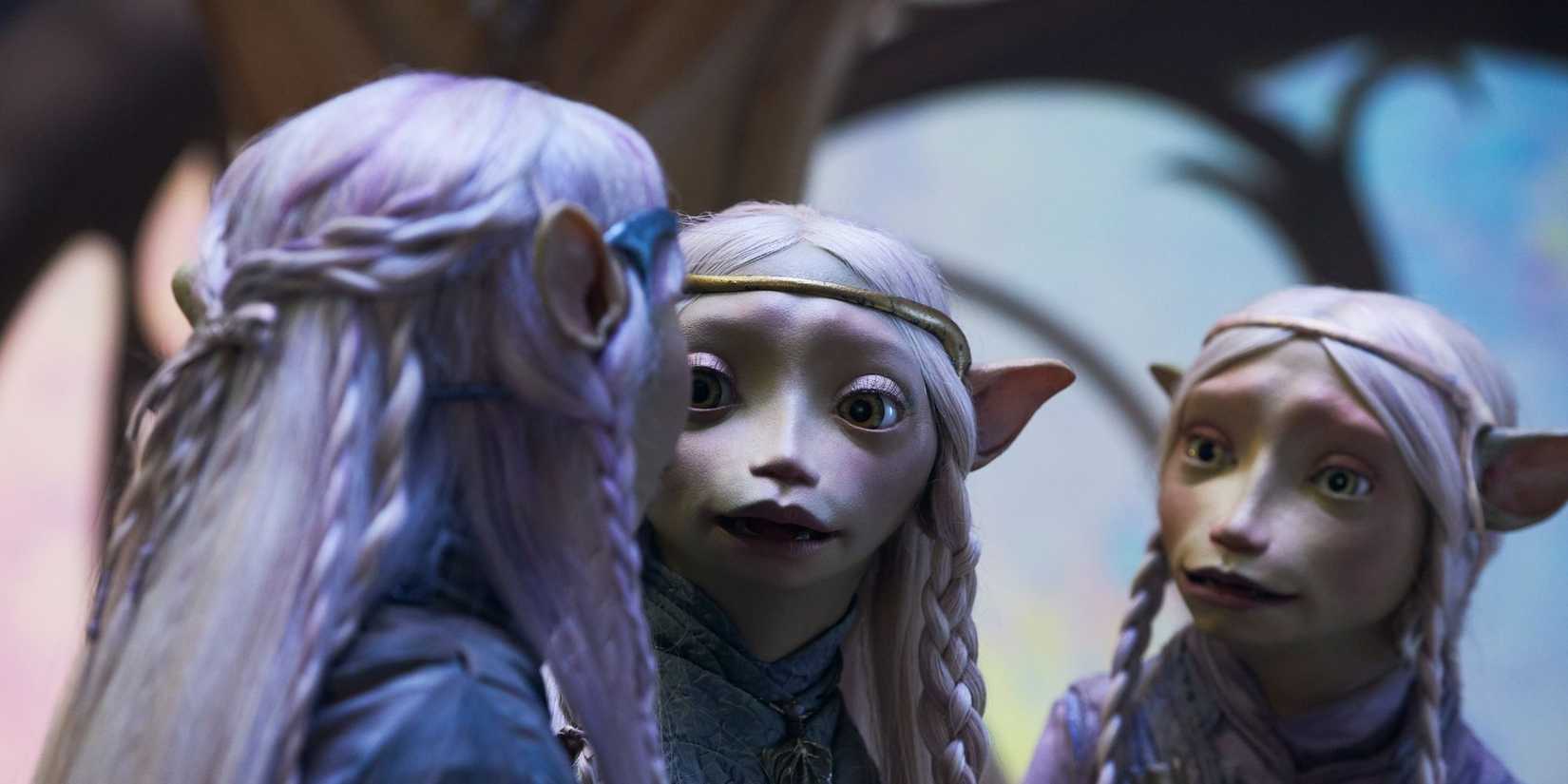 Three Gelfling talk to each other with concerned expressions in The Dark Crystal: Age of Resistance