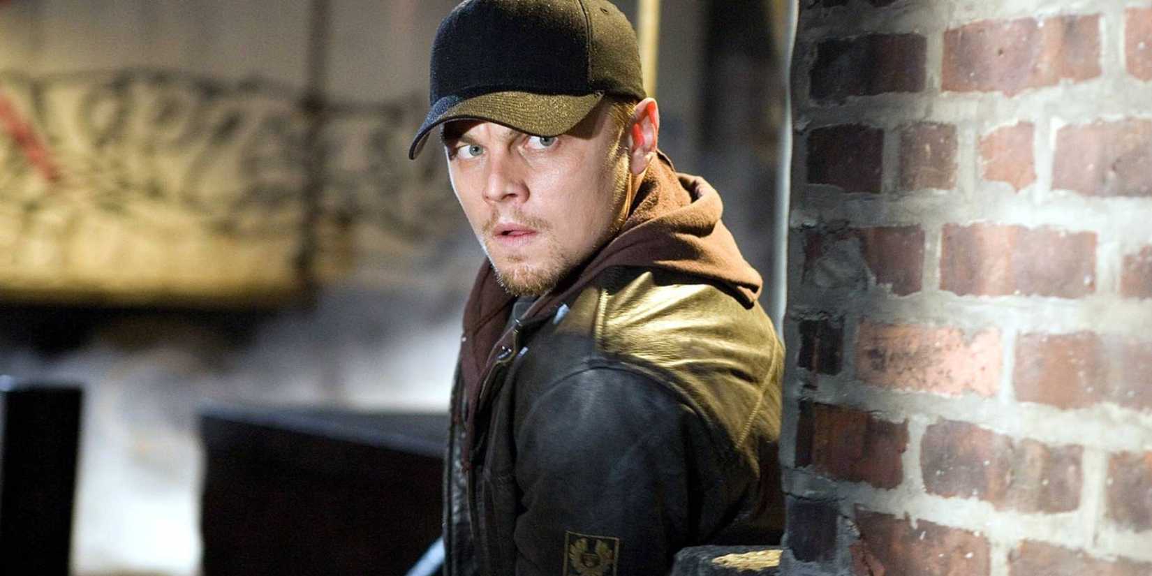 Leonardo DiCaprio in The Departed, looking shady with gun 