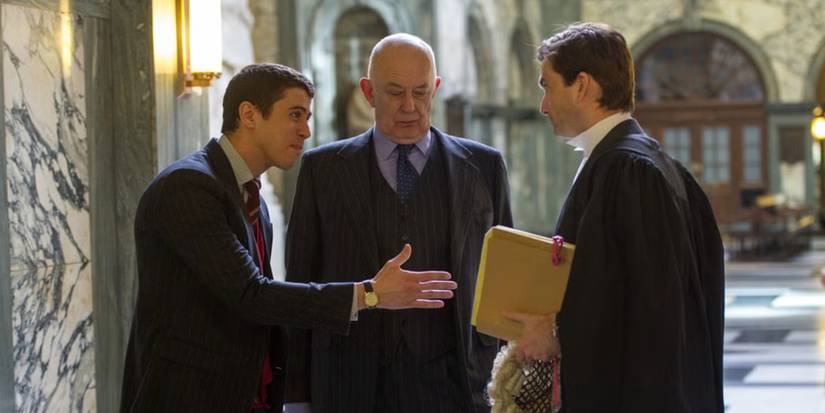 Toby Kebbell trying to shake David Tennant's hand in a courthouse in The Escape Artist
