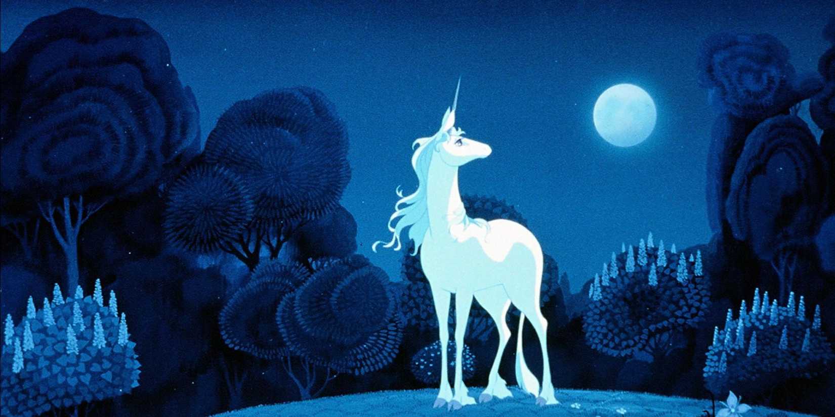 A lone unicorn looks up at the moon in the night sky in The Last Unicorn