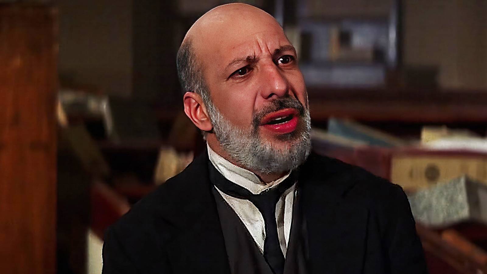 Erick Avari wears a suit and looks off camera in The Mummy