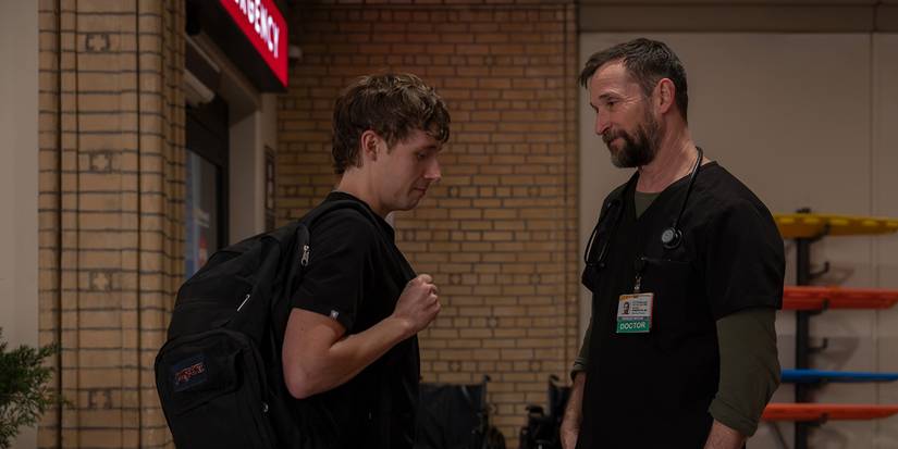 Dennis and Robby standing outside of the hospital talking in The Pitt.