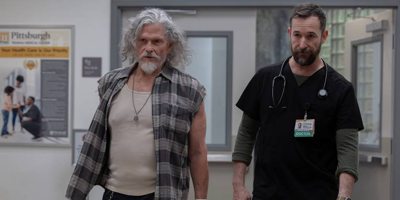 Duke walking down a hallway with Robby in The Pitt.