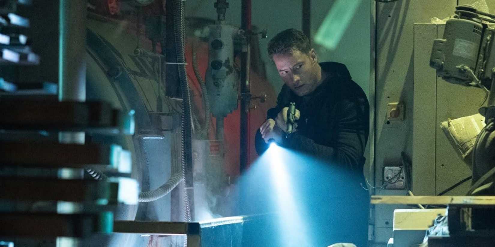 Colter Shaw (Justin Hartley) looks around in a warehouse in the 'Tracker' episode "Struck"