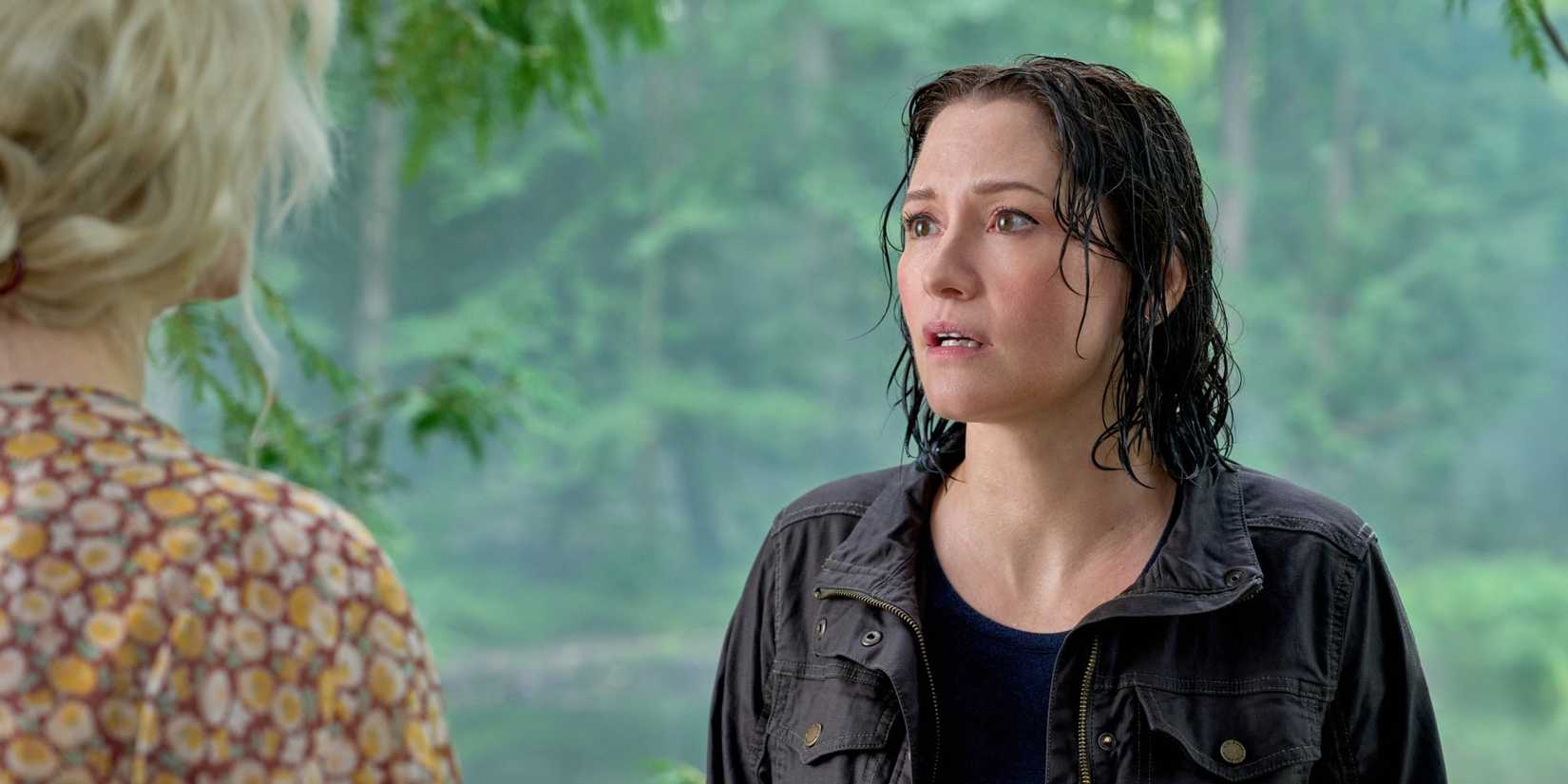 A soaking wet Kat Landry talking to a young Fern by the pond in The Way Home Season 4