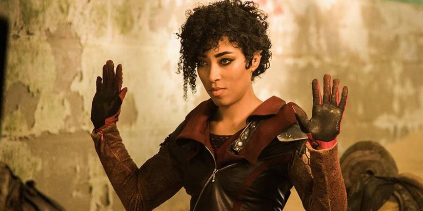 Adriyan Rae holding hands up and smirking in Vagrant Queen