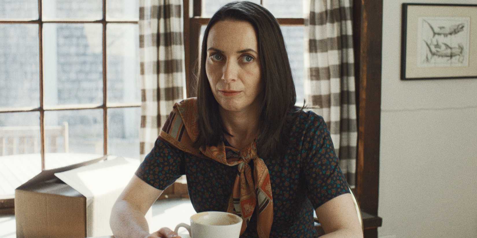 Kate O'Flynn sitting with a cup of coffee in Widow's Bay