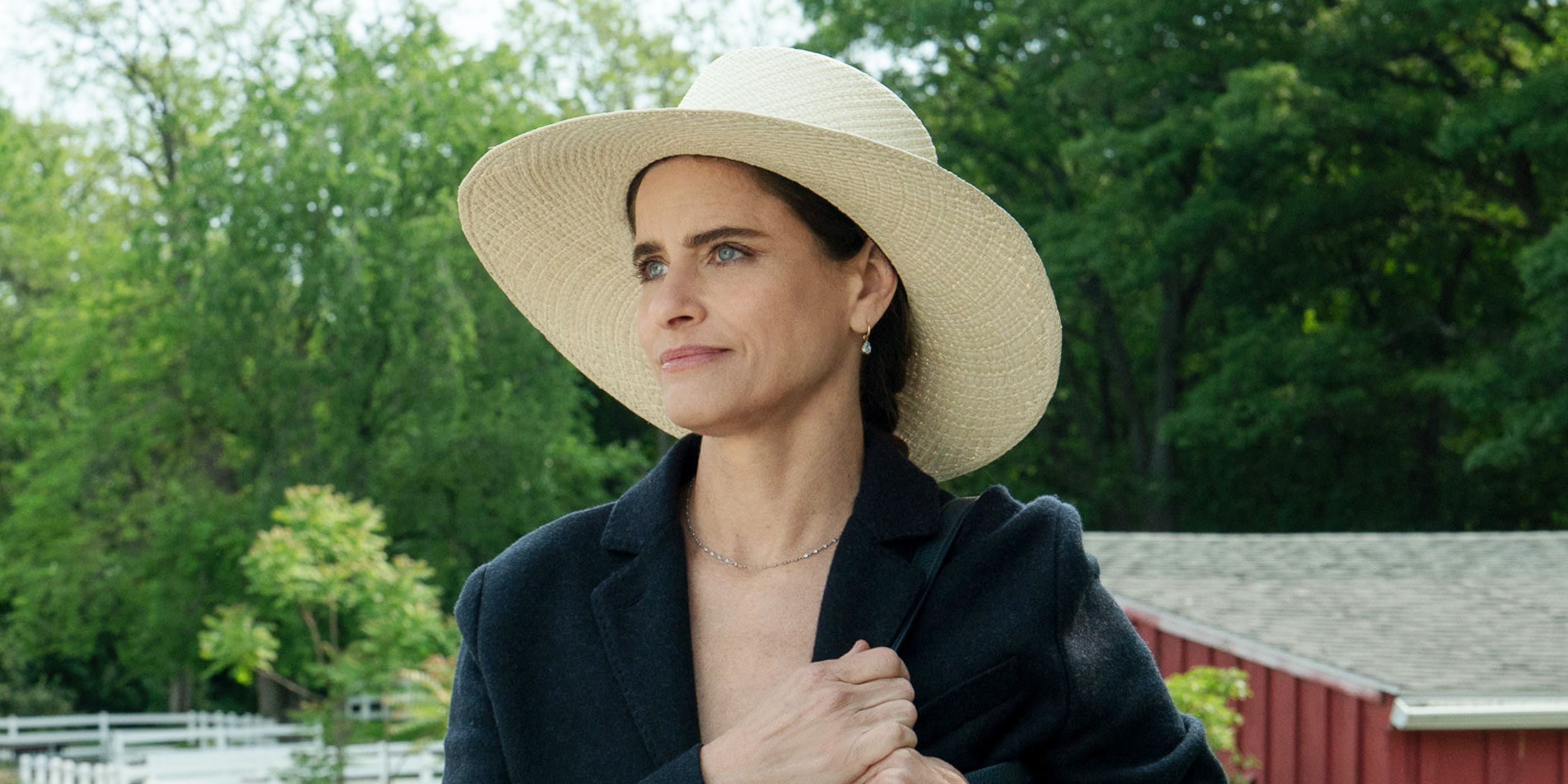 Amanda Peet holding a bag over her shoulder in Your Friends & Neighbors Season 2