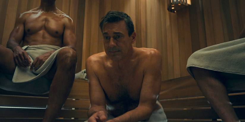 A shirtless Jon Hamm as Coop, nervously sitting in a sauna, in Your Friends & Neigbhors Sesaon 2.