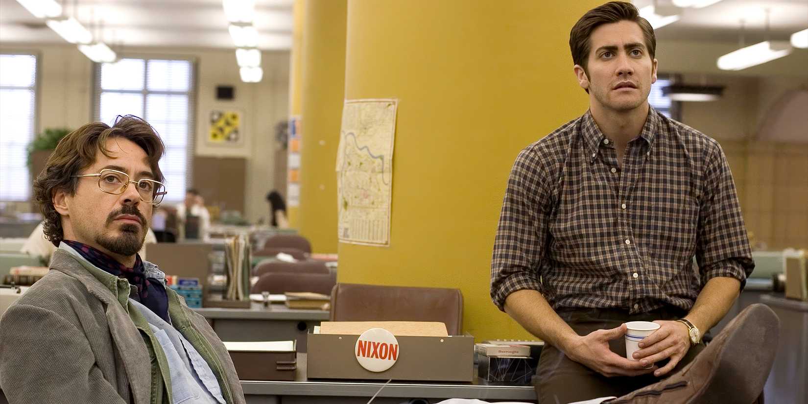 Paul Avery and Robert Graysmith sitting in an office. 
