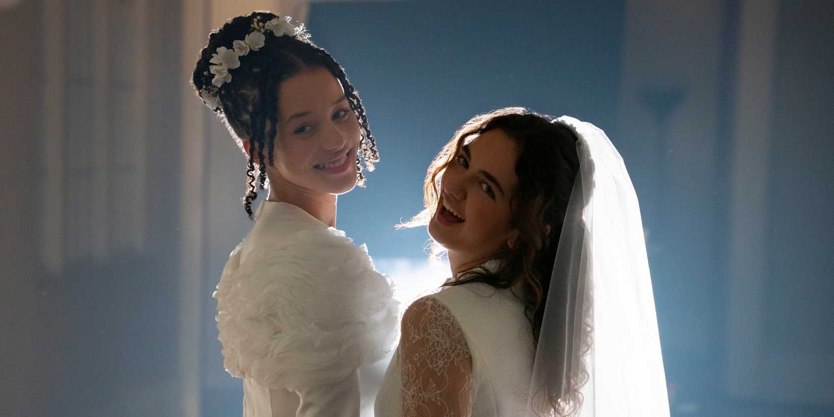 Chase Infiniti as Agnes with Mattea Conforti as Becka in wedding dresses in The Testaments